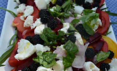 Salade d'été, mélange de fruits et de légumes avec des tomates, mozzarella et mures