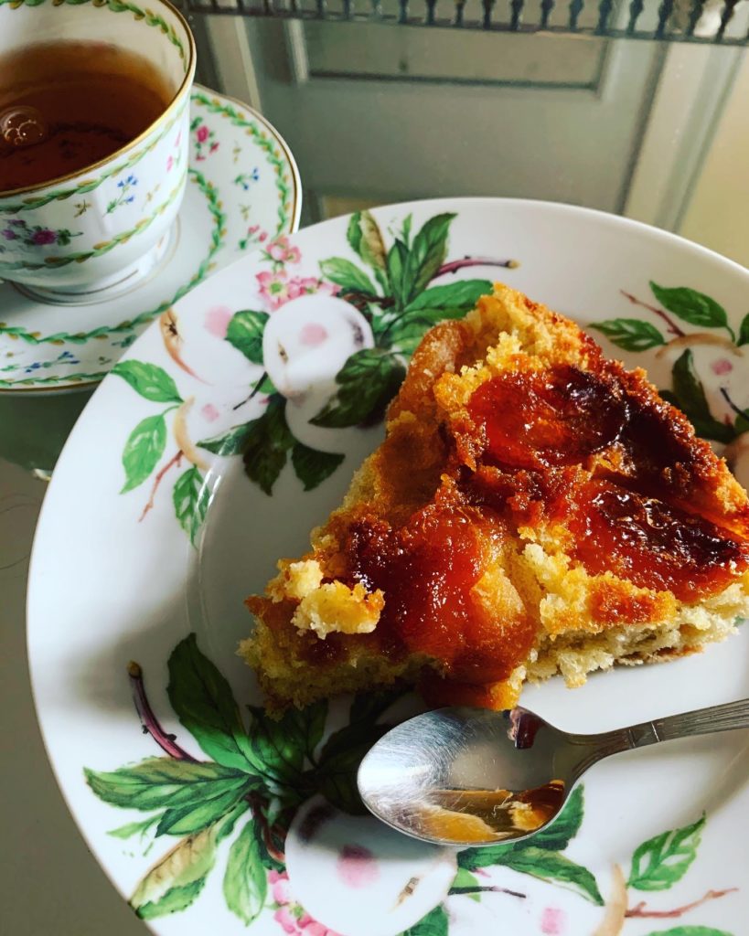 part de gâteau renversé aux abricots secs servi avec son thé